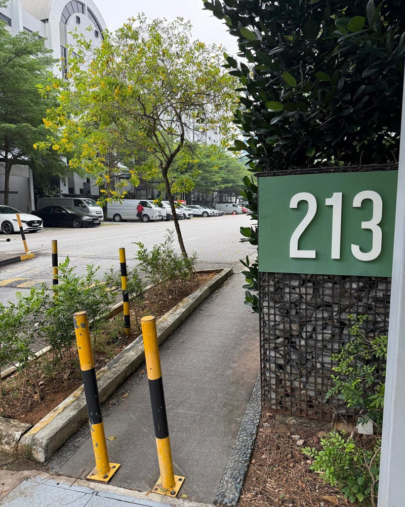 Green Block 213 sign beside the walkway